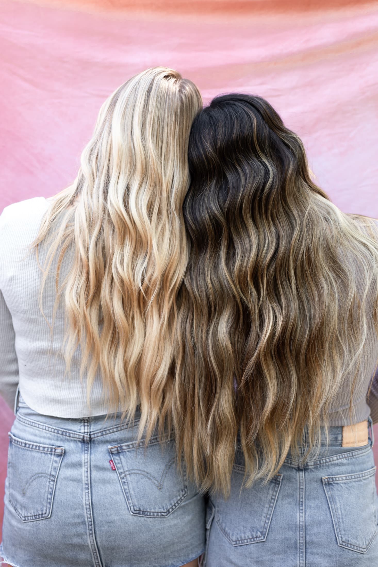 Two clients showing hand tied extension results at Bloom Salon ATX